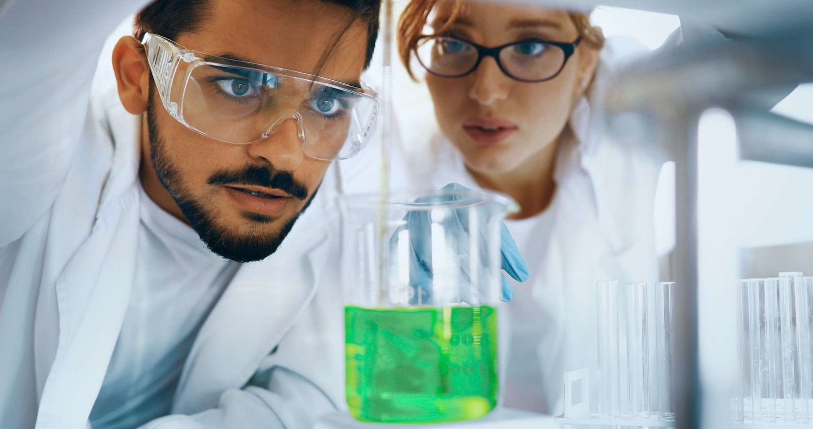 Young students of chemistry working in laboratory